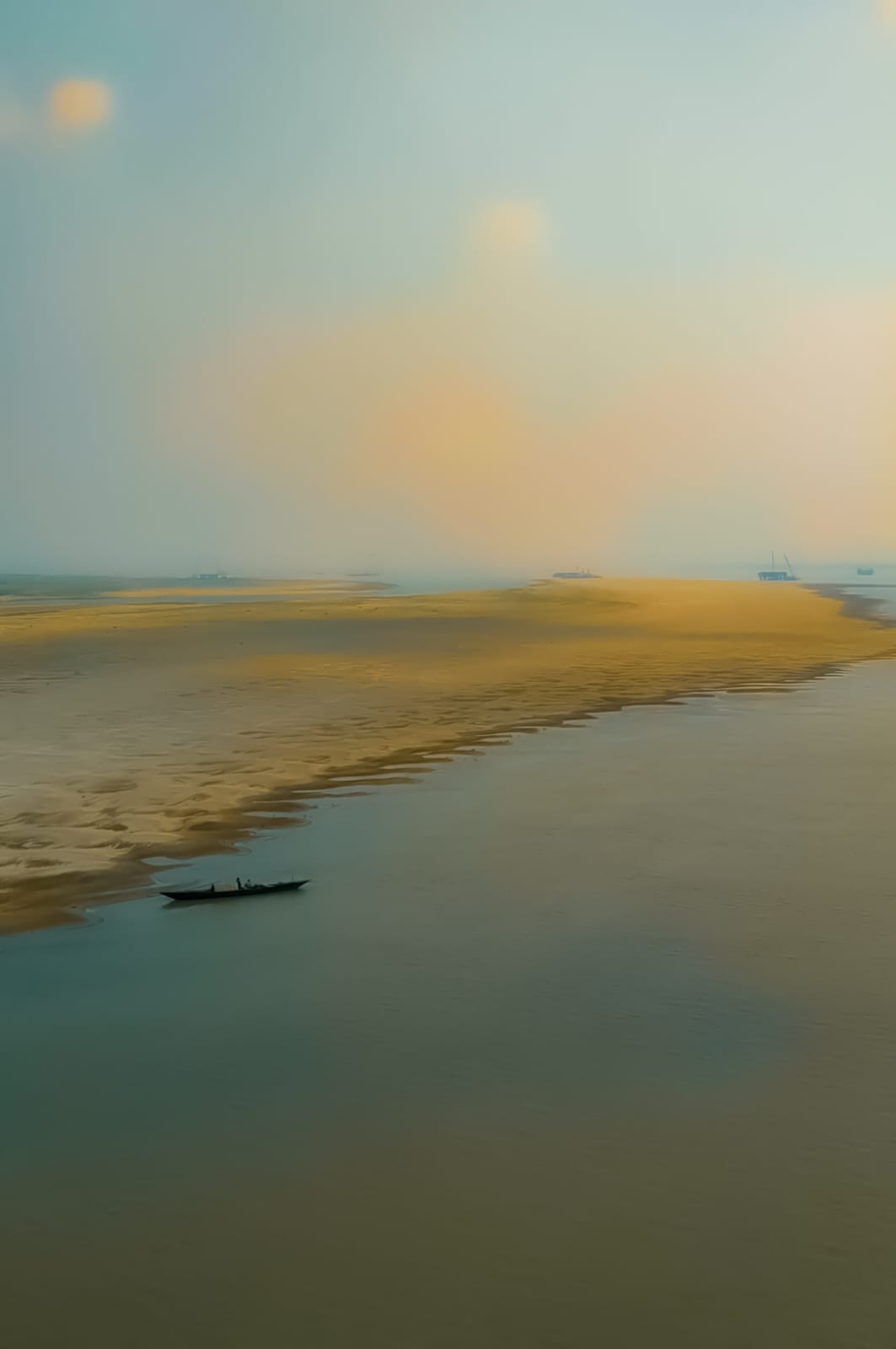 Small boat on a river sandbar at sunset
